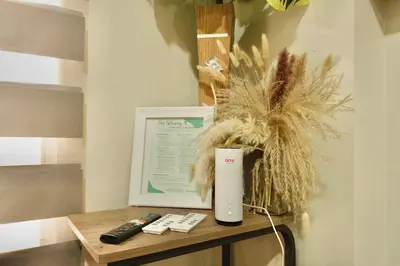 a table with two remote controls and a thermos at Chic Getaway Near Airport in Manila