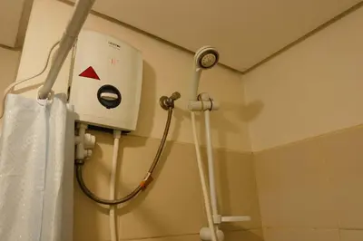 a shower in a hospital room with a shower at Chic Getaway Near Airport in Manila