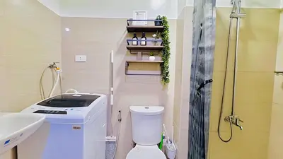 a bathroom with a toilet and a sink and a shower at 1 Bedroom Unit near MOA & NAIA Terminal in Manila