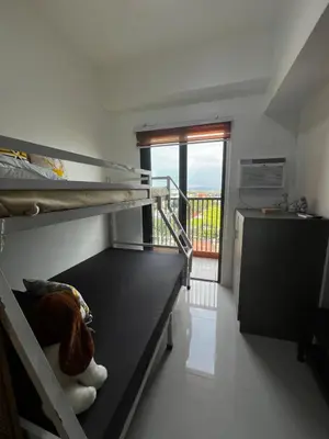 a room with two bunk beds and a balcony at Modern Studio with Balcony and City View Near BGC in Manila
