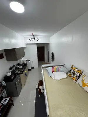 a room with two bunk beds and a kitchen at Modern Studio with Balcony and City View Near BGC in Manila