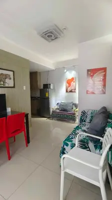 a living room with a couch and a table at Two-Bedroom by Metro Staycation in Manila