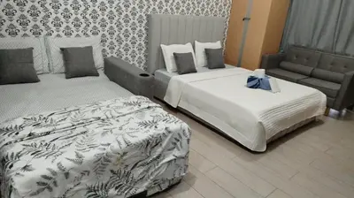 a hotel room with two beds with a bow on it at Gambino Homes in Manila