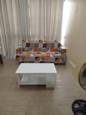 a living room with a couch and a coffee table at Gambino Homes in Manila