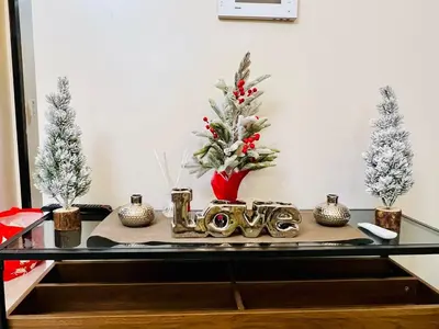 a table with christmas decorations on it with trees at 3BR Penthouse Suite Sunset View in front of Okada in Manila