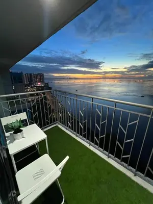 a balcony with a view of the ocean at 3BR Penthouse Suite Sunset View in front of Okada in Manila
