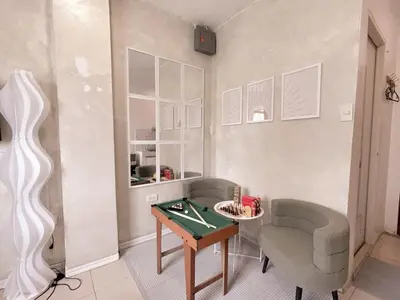 a living room with a table and a chair at Boho Scandinavian with free Netflix, Wifi & Parking in Dasmariñas