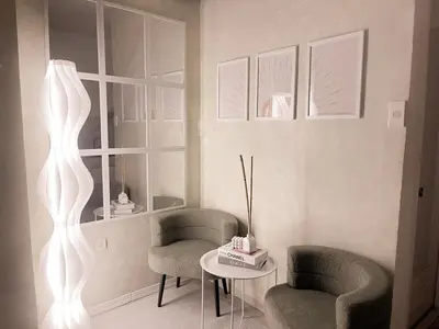 a living room with two chairs and a table at Boho Scandinavian with free Netflix, Wifi & Parking in Dasmariñas