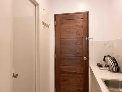a bathroom with a wooden door next to a sink at Boho Scandinavian with free Netflix, Wifi & Parking in Dasmariñas