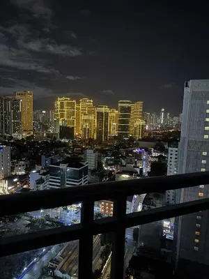 a view of a city skyline at night at The Gramercy Residences in Manila