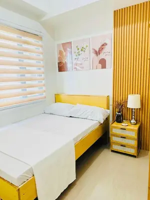 a bedroom with two beds and a window at Family Oasis at Leaf with Netflix in Muntinlupa in Manila