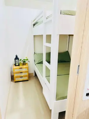 a white bunk bed in a small room at Family Oasis at Leaf with Netflix in Muntinlupa in Manila