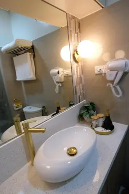 a bathroom with a white sink and a mirror at Urban Luxe Suite - Shore 2 Residences, Steps to Mall of Asia Complex, Pasay City in Manila