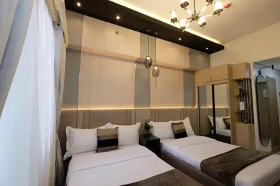 a room with two beds and a mirror at Urban Luxe Suite - Shore 2 Residences, Steps to Mall of Asia Complex, Pasay City in Manila