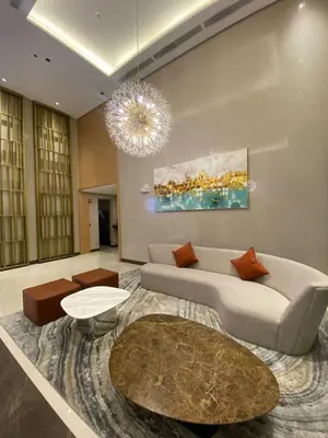 a living room with a couch and a chandelier at Sunnyplace Residences Near NAIA Airport in Manila