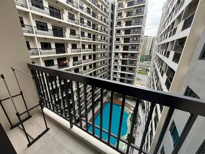a balcony of a apartment building with a swimming pool at Sunnyplace Residences Near NAIA Airport in Manila
