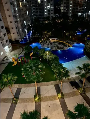 an aerial view of a pool at night at Thrifty Comfy Luxe Stays in Manila
