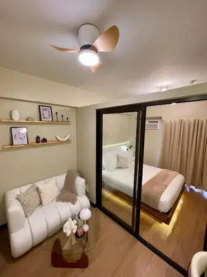 a bedroom with a bed and a couch and a mirror at Balé Cù Calathea Place near airport road NAIA and MOA in Manila