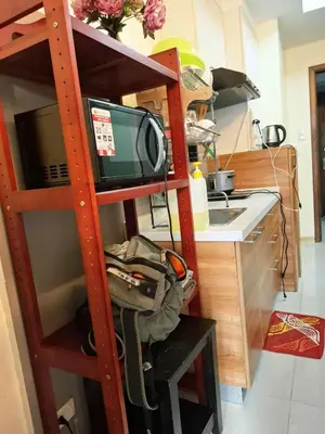 a kitchen with a ladder with a tv and a sink at Sunshine100PioneermMandaluyong PoolGymBilliardsPlaygroundTVWifi in Manila