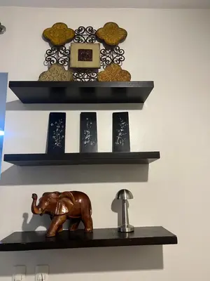 a shelf with a statue of an elephant on it at Mandaluyong HomeBest Place to Stay! in Manila