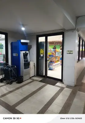 a grocery store entrance with a grocery cart in a store at Resort Inspired Condo Beside NAIA Terminal 1 Near Okada and City of Dreams in Manila