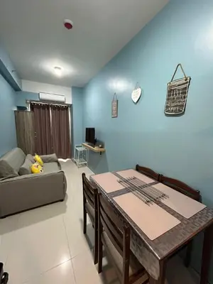 a living room with a table and a couch at MK's place in Manila