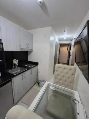 a small kitchen with a chair and a sink at Condotels in Sucat Road in Manila