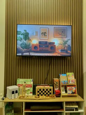 a shelf with a tv on a wall with atainment at The Azelea Suites By Azel in Manila