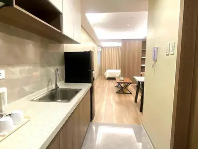 a kitchen with a sink and a refrigerator at Manila City Center Executive Apartments near Ayala Mall and PITX in Manila