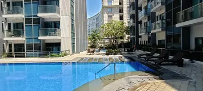 a swimming pool in the middle of a building at 1 bedroom Condotels Across terminal 3 airport in Manila