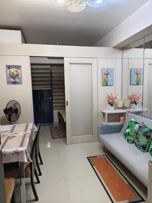 a living room with a couch and a table at Juliza Staycation near Mall Of Asia in Manila