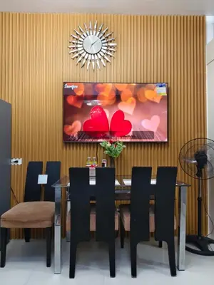 a dining room with a table and black chairs at Juliza Staycation near Mall Of Asia in Manila