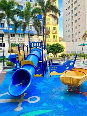 a water park with a blue slide and a slide at Juliza Staycation near Mall Of Asia in Manila