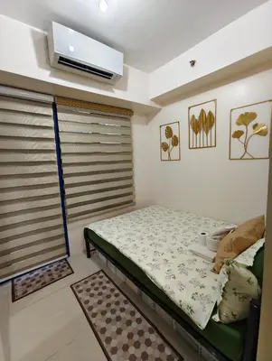 a small bedroom with a bed in a room at Juliza Staycation near Mall Of Asia in Manila