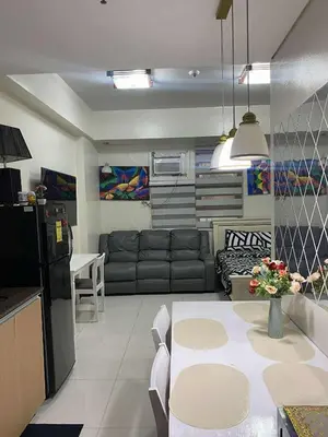 a kitchen and living room with a couch and a table at Vienna's Condotel in Manila