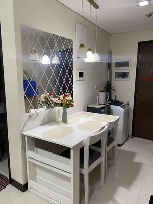 a kitchen with a white island with two sinks at Vienna's Condotel in Manila