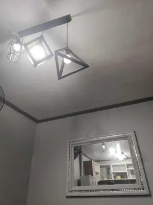 a mirror and lights in a room with a ceiling at AET Staycation House in San Pedro