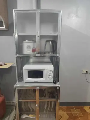 a microwave on a shelf in a refrigerator at AET Staycation House in San Pedro