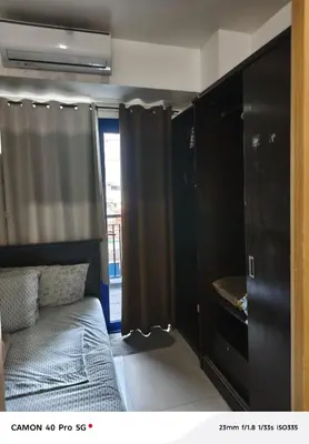 a bedroom with a bed and a black closet at Moa view sea Residences condotel in Manila