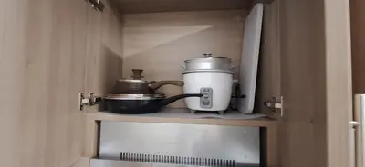 a coffeemaker sitting on a shelf in a cupboard at JCs Staycation Fame Residences in Manila