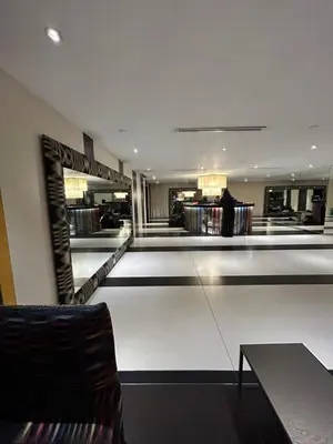 a store lobby with a person standing in a store at Roomi Stays Acqua Private Residences in Manila