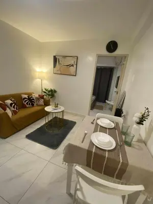 a living room with a couch and a table at D'Hauz 2- Pet Friendly unit in Manila