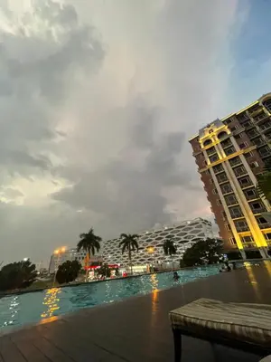 a view of a swimming pool with buildings in the background at D'Hauz 2- Pet Friendly unit in Manila