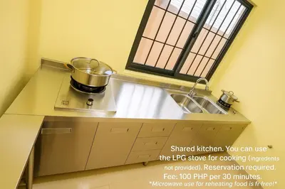 a kitchen with a sink and a pot on a stove at T1 Stay Airport Residences - Tower A in Manila