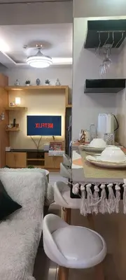 a dining room with a table with white chairs at Staycation by Jia cozy corner in Manila