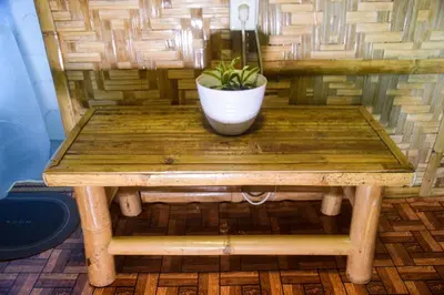 a wooden table with a potted plant on it at CLBC Bahay Kubo in Tagapo