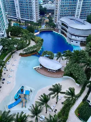 a large pool at a resort with a slide at Azure SYM Staycation in Manila