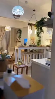 a living room with a kitchen with a table at Azure SYM Staycation in Manila