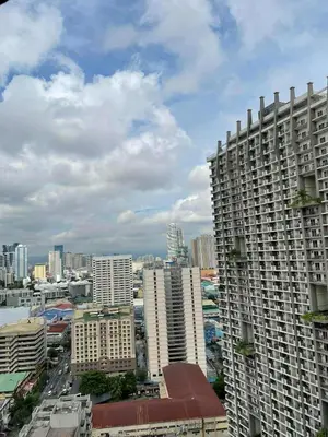 a view of a city with tall buildings at Sunshine100 1Bedroom 65InchesTV PoolGymBilliardPlayground in Manila