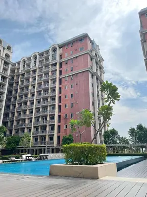 a large apartment building with a pool in front of it at D'Hauz 3 - Pet Friendly unit in Manila